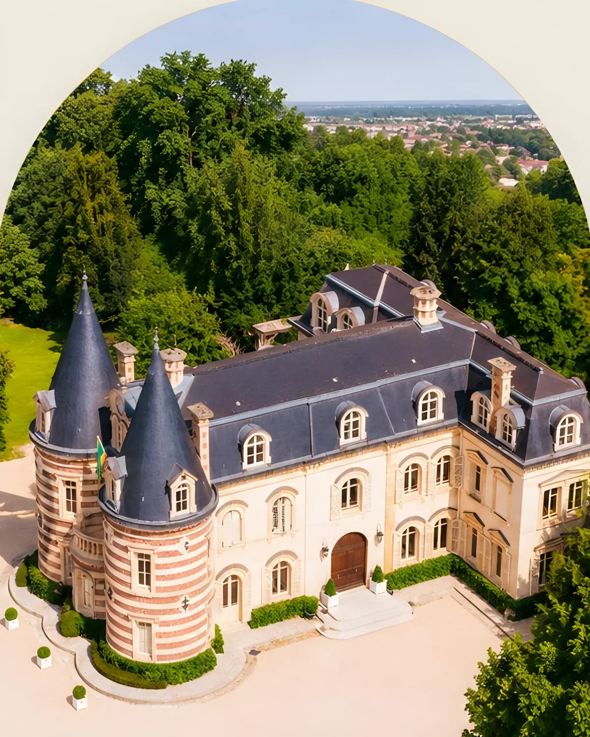 Château Comtesse Lafond from the air, its two striped turrets among the trees