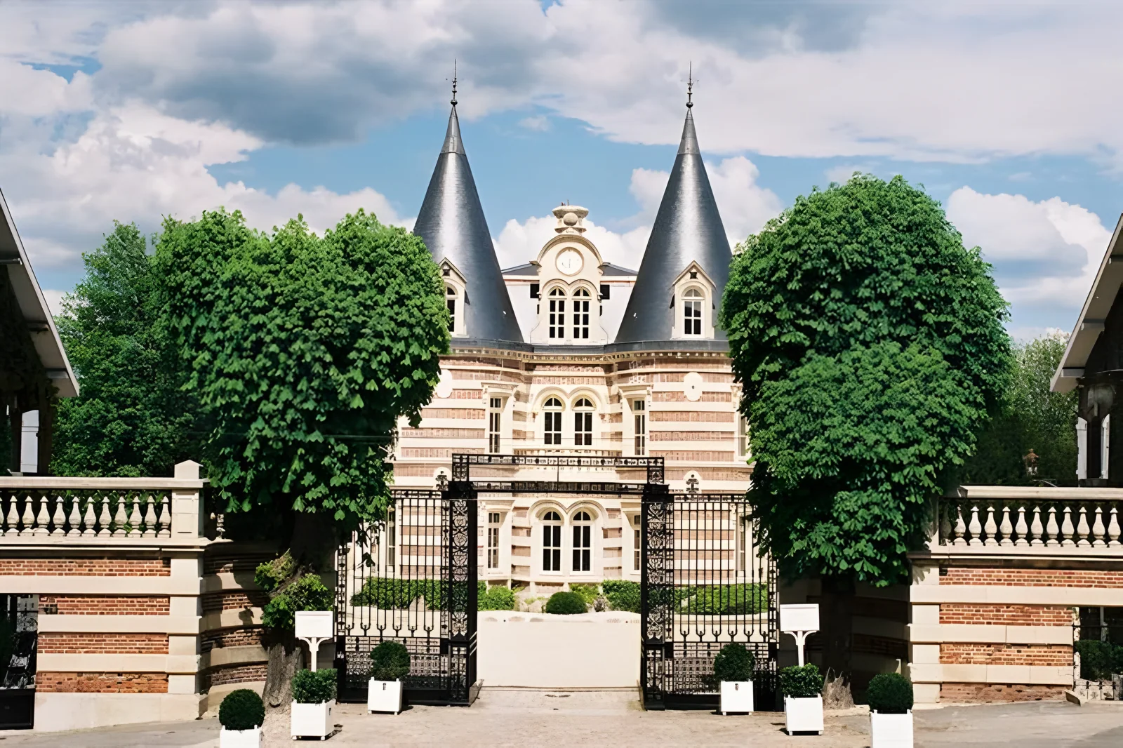 Château Comtesse Lafond behind its gates, with the two slate turrets
