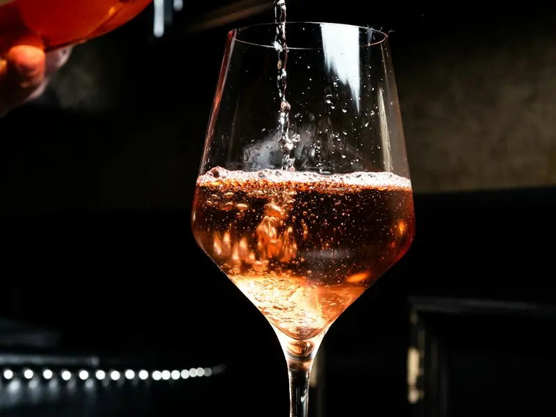 A glass of champagne being poured